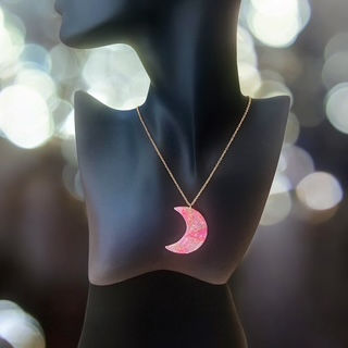 Moon necklace on a gold moon necklace chain.