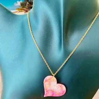 A heart necklace with a gold heart necklace chain for a romantic style.
