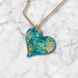 A heart necklace with a gold heart necklace chain for a romantic style.