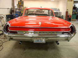 Back view of a finished red 1961 Pontiac Bonneville.