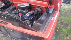 Engine on red Ford F100 Truck before work done on it.