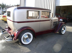 1929 Ford Essex repainted silver with maroon trim and fenders.