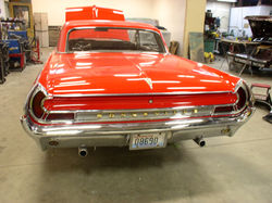 Another back view of a red 1961 Pontiac Bonneville.