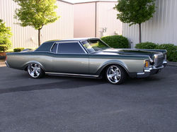 1972  Lincoln Continental with green top and silver bottom.