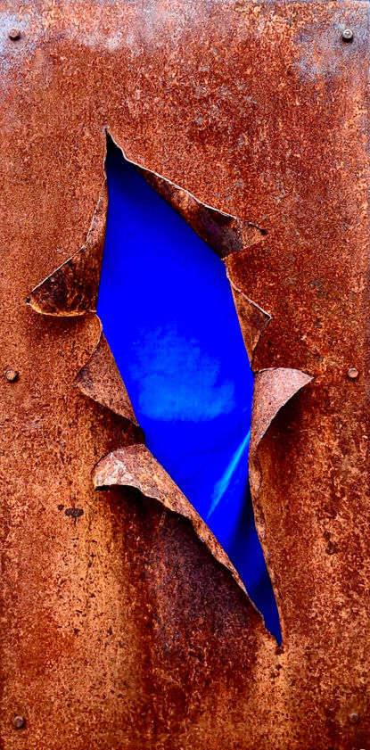 a metal hanging by Ewen Macdonald