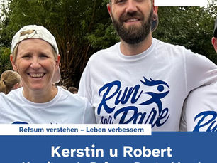 Kerstin and her husband in white "Run for Rare" shirts outdoors.