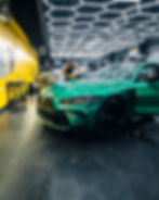 Green BMW in garage