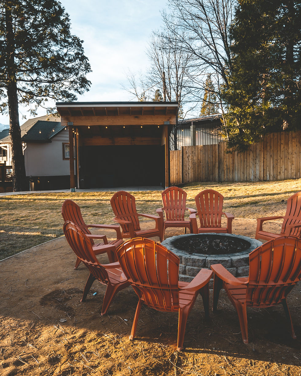 fire pit surrounded by Adirondack chairs