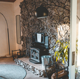 Common Room at LOGE Camp Hotel in Mount Shasta. Pot Belly Fireplace and Cozy Atmosphere.