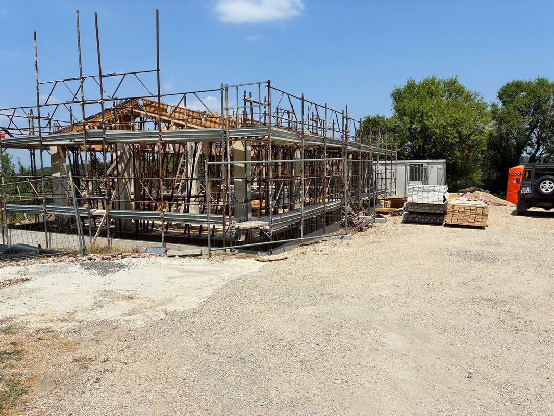 New building construction with timber frame and scaffolding
