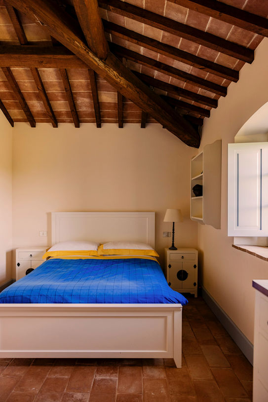Cozy bedroom with exposed beams and countryside views