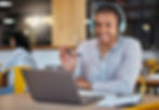 Smiling man video conferencing on laptop