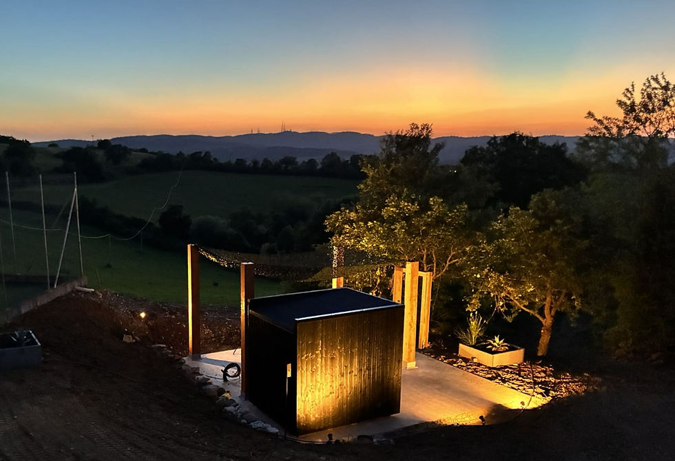Sunset view across the wellness area and tennis court at Poggio Posillipo, Umbria