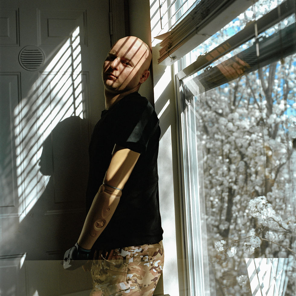 Ukrainian war veteran in black shirt by window
