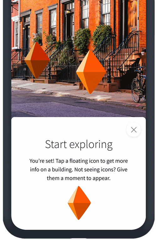Floating markers in front of an NYC residential building demonstrate how the StreetScape feature works in the StreetEasy app.