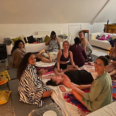 women sitting and lying down for a group wellness treatment