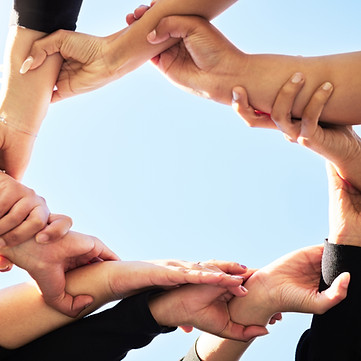  a team with their hands in circle for support, strength and unity