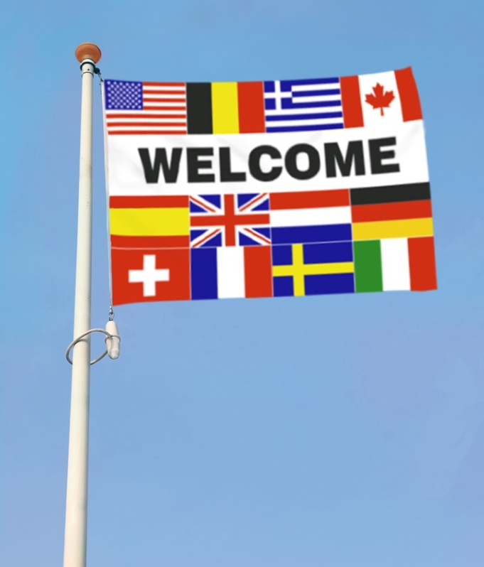 Miniatyrbilde: Flagg med velkomsttekst og flagg fra forskjellige land.
