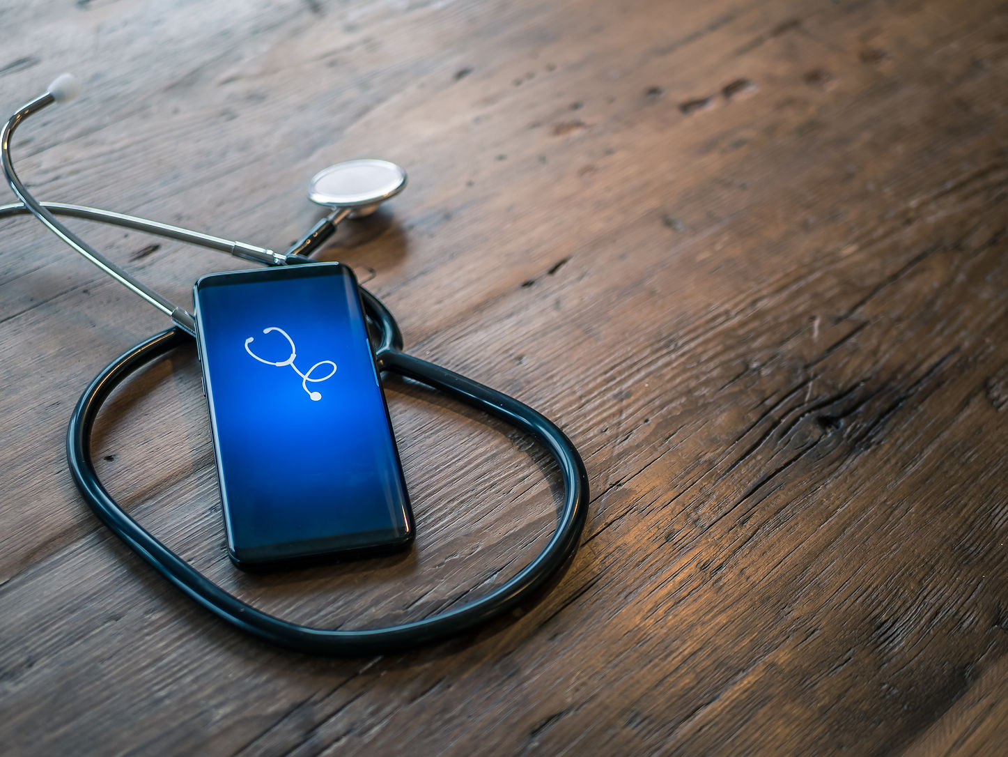 Mobile phone with healthcare app on wood