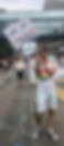 man marching in pride parade with "Deaf, Gay, and Proud" sign