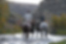 A cowboy and a cowgirl are crossing middle creek to begin the horse drive at Silver Spur Ranch.