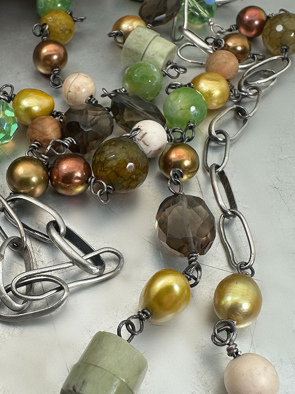 Thumbnail: Long sterling chain with all sorts of greens and browns