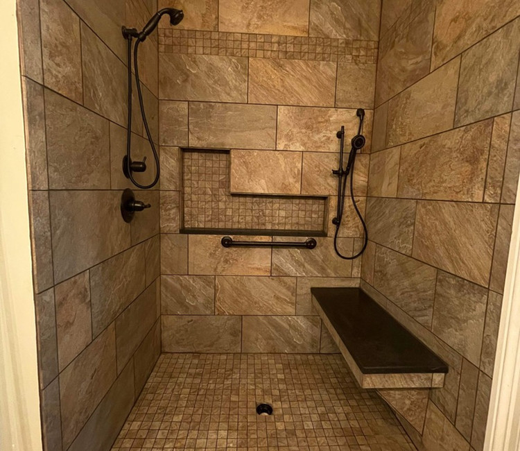 Walk-in shower tile installation in Chattanooga, TN with bench seating, grab bar, and custom shower layout.