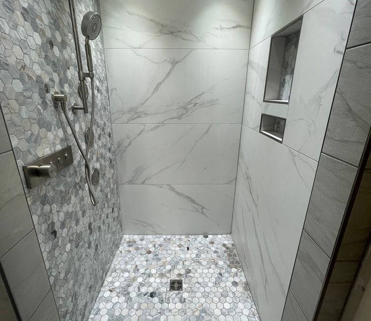 Shower remodel in Chattanooga, TN with hexagon tile floor, accent wall tile, and recessed niche.