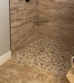 Curbless barrier-free shower with natural stone tile design, built for wheelchair accessibility by Chattanooga Tile Company in Chattanooga, Tennessee.