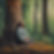 person resting against a tree meditating, deep in the forest.jpg