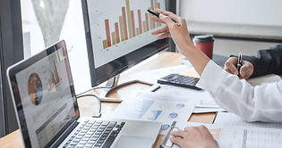 Professional Person Pointing to Data Visualizations on Computer.png