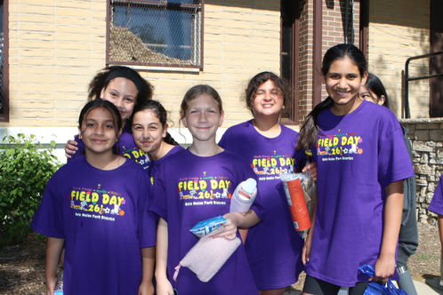 Students smiling in matching T-Shirts