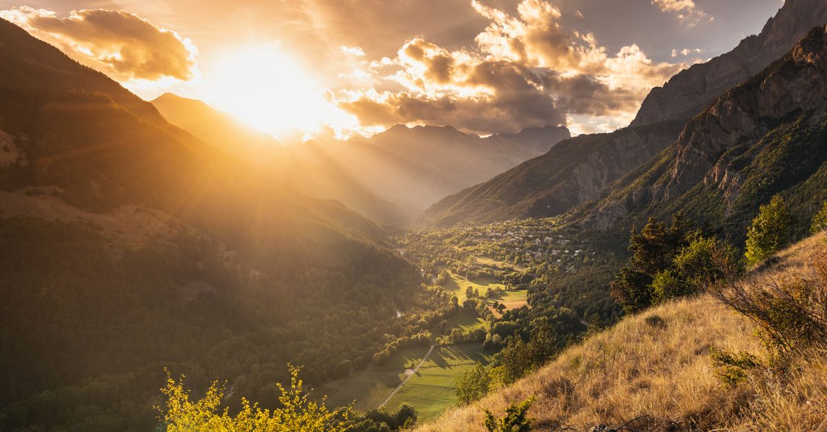 A warm mountain valley at sunset in France, evoking the life David has built overseas.