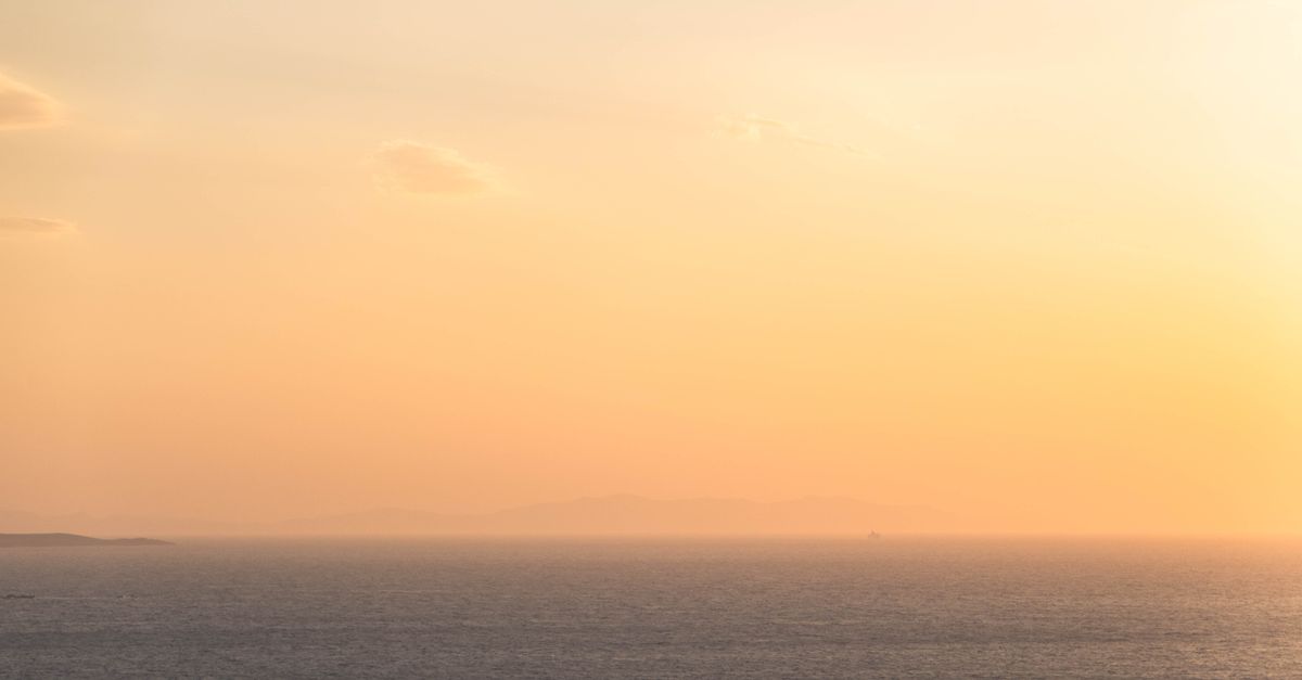 A warm coastline at golden hour, evoking the settled expat life James has built abroad.