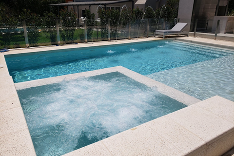 Fotografía de piscina construida por Natacity, con solarium, hidromasaje y cascada, diseñada por equipo especializado para proyectos residenciales y comerciales en Buenos Aires.