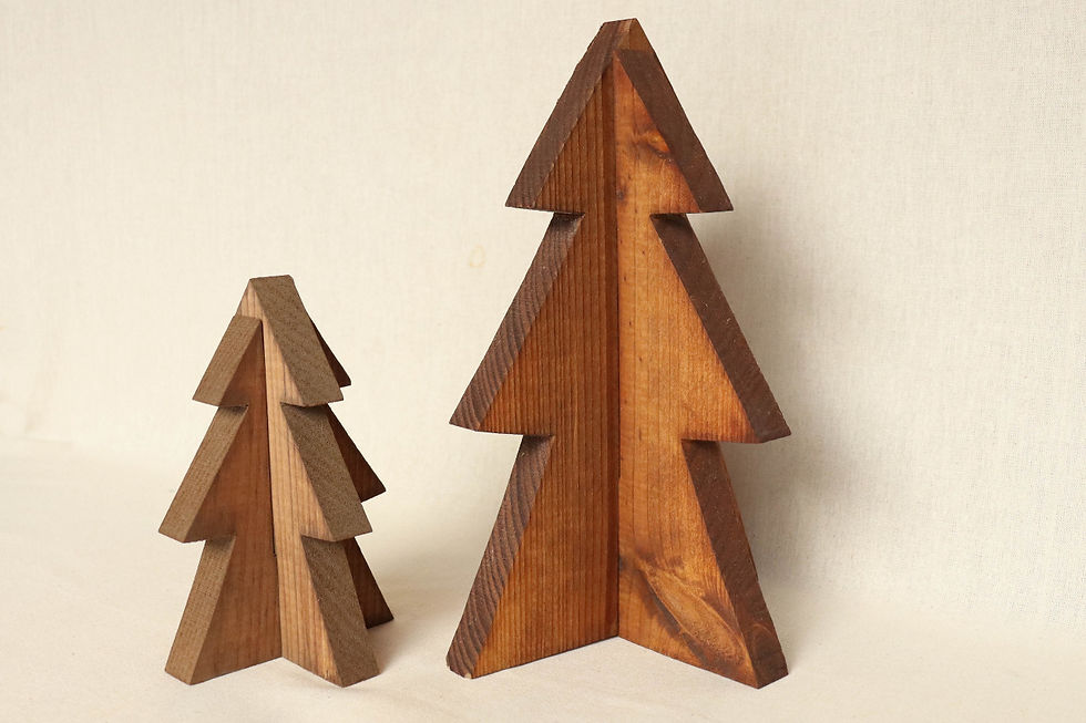 Two wooden tree sculptures, one larger, one smaller, on a light beige background. Both have a natural wood finish, creating a warm, rustic feel.