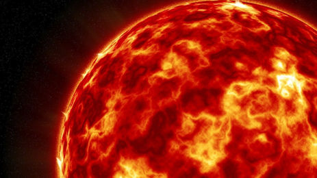 Close-up of the Sun with swirling orange and yellow textures against a dark space background, showing intense heat and energy.