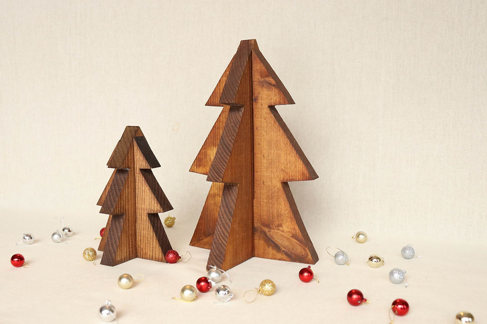 Wooden tree sculptures on beige background, surrounded by small red, gold, and silver ornaments, creating a festive, minimalist scene.