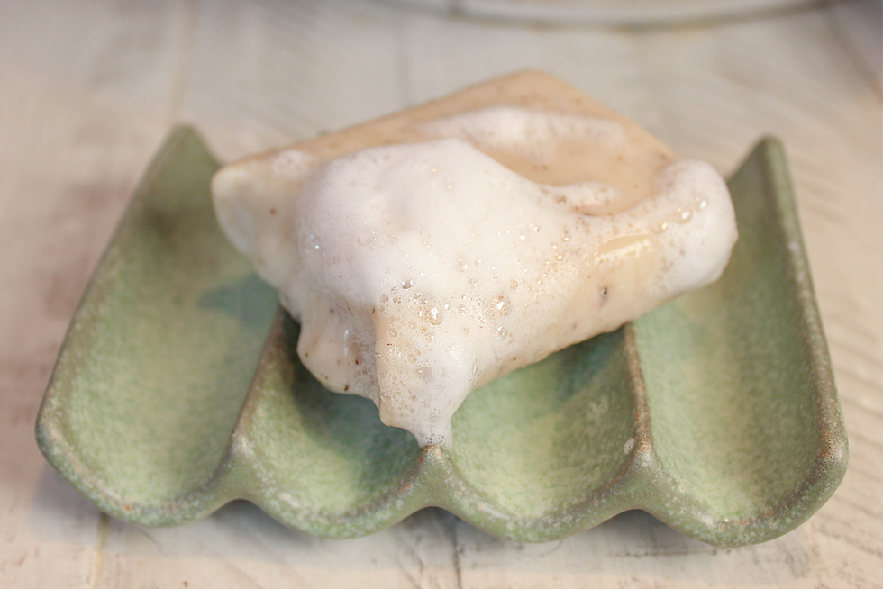 Thumbnail: Foamy soap on a green ceramic soap dish
