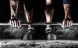 Lifting barbell with chalk