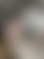 mix white dog laying on couch