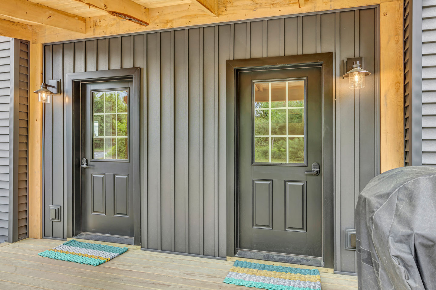 Gray doors on a wooden exterior wall.
