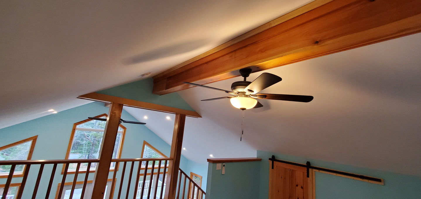 Ceiling fan in a wooden interior space.