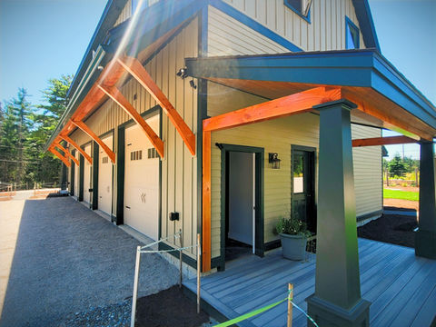 Modern building with orange beams and large windows.