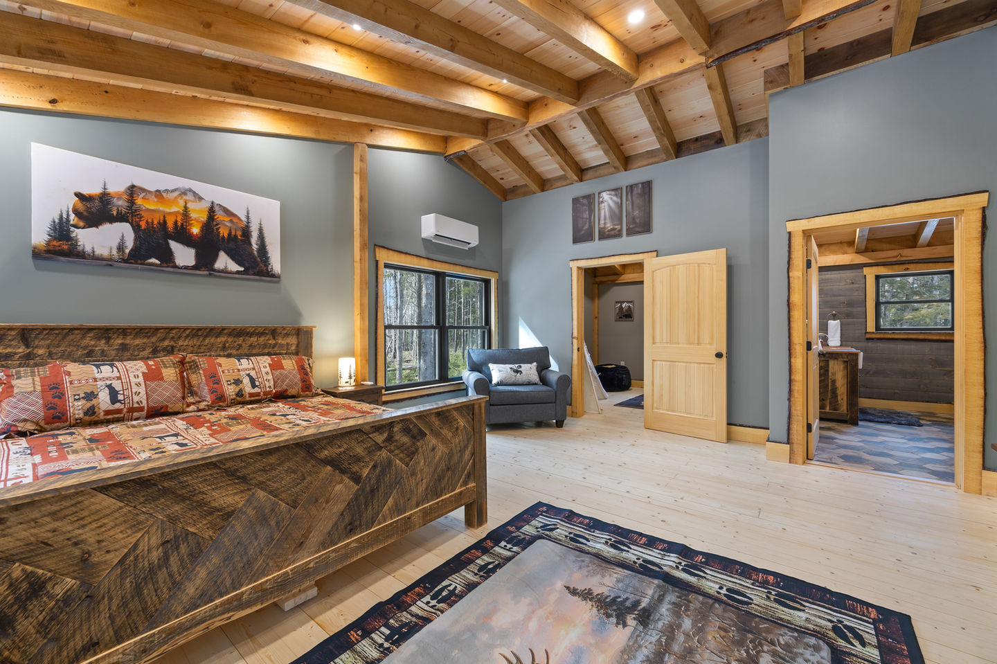 Cozy bedroom with wooden ceiling and rustic decor.