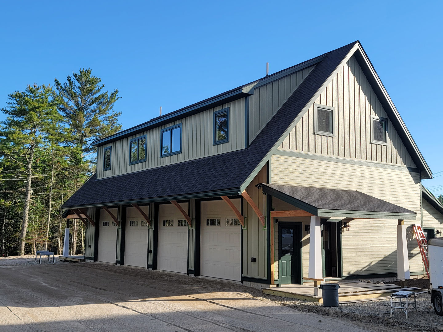 Building with black roof and beige siding.