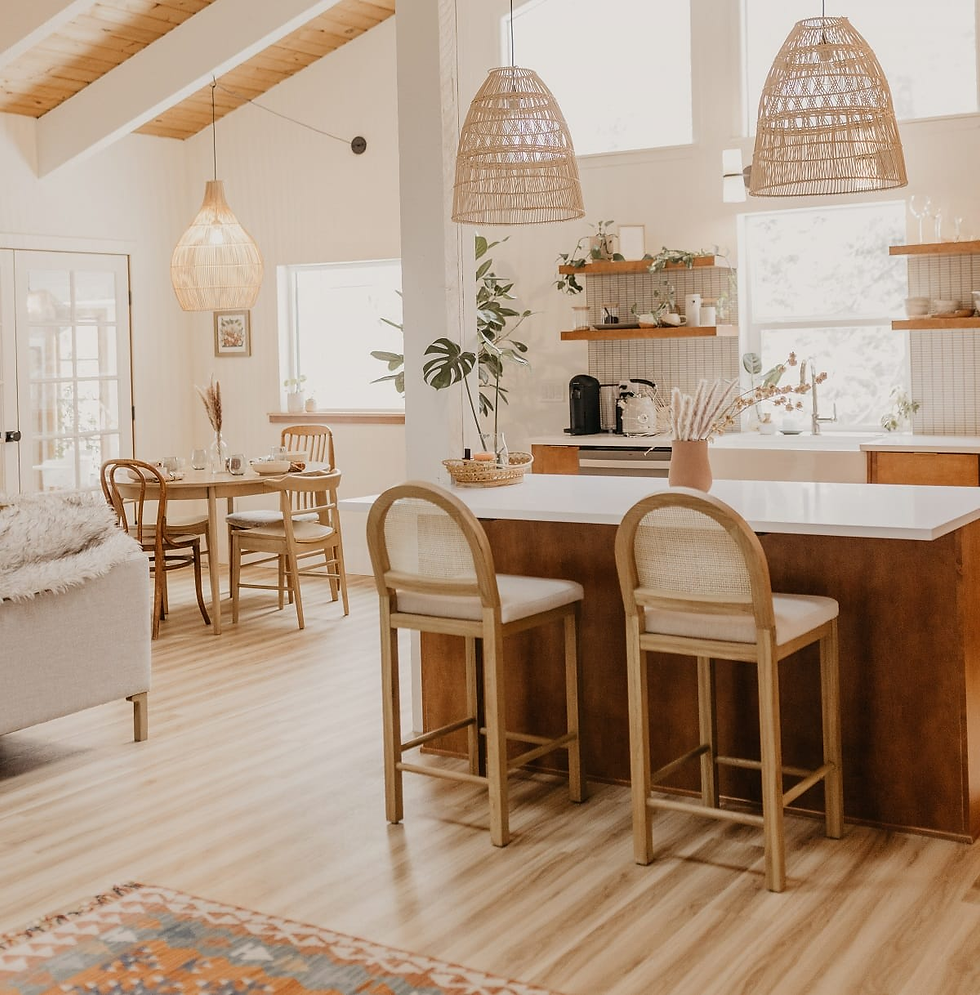 Open-concept kitchen and living room with island seating and natural light