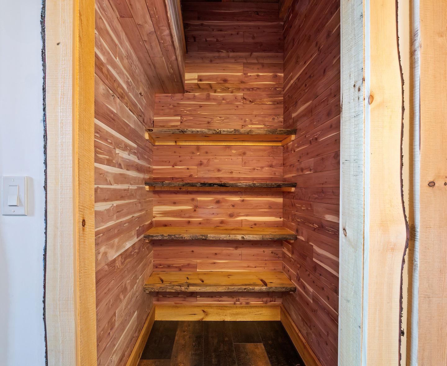 Wooden staircase with rustic walls.