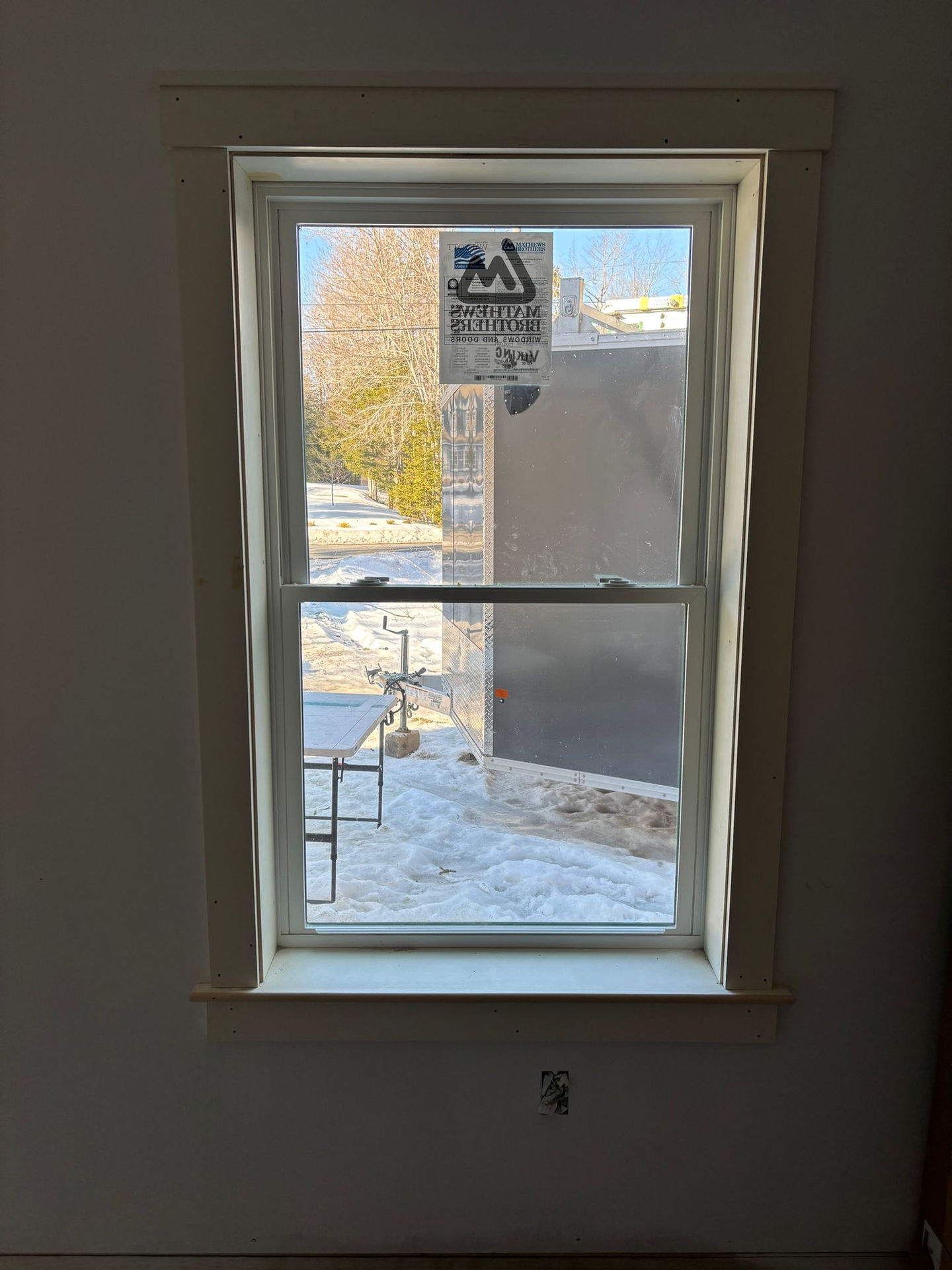 Small window view with construction outside.