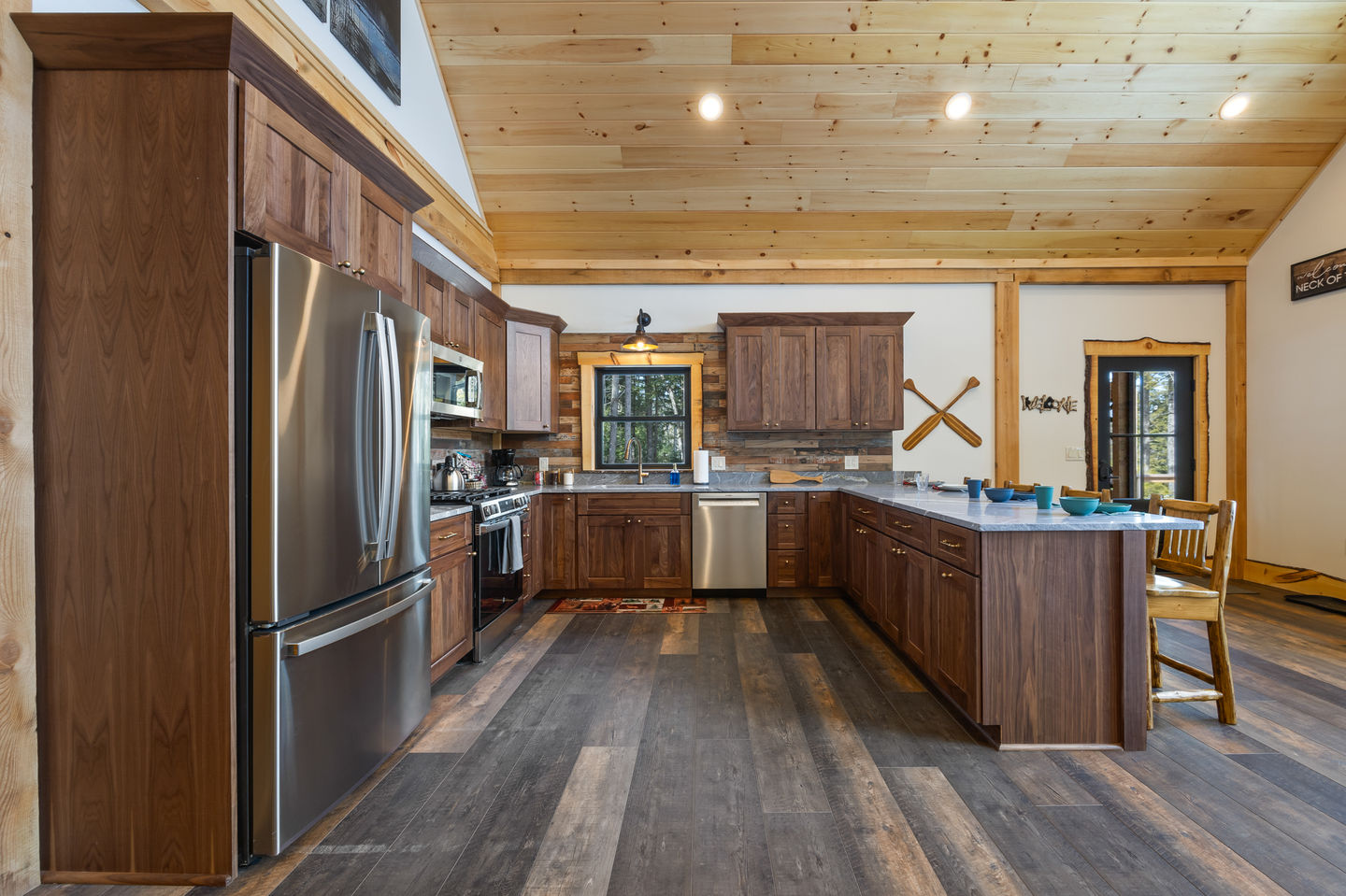 Rustic kitchen with wooden cabinets and stainless steel appliances.